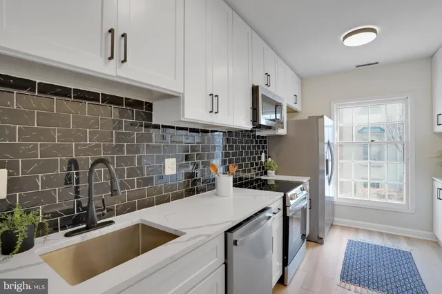 a kitchen with a sink stove and refrigerator