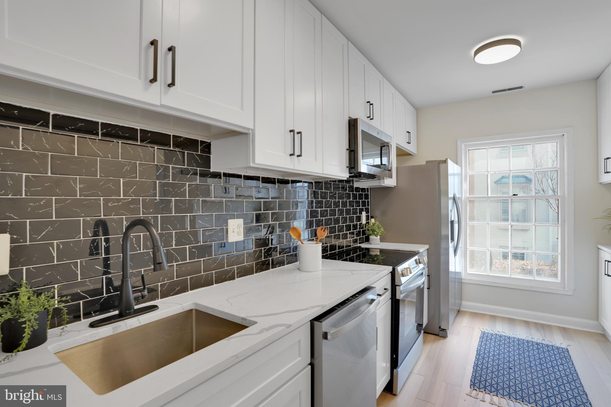 4339 Massachusetts Avenue Northwest, Unit 4339 Washington, DC 20016 - Photo 7 of 25 a kitchen with a sink stove and refrigerator