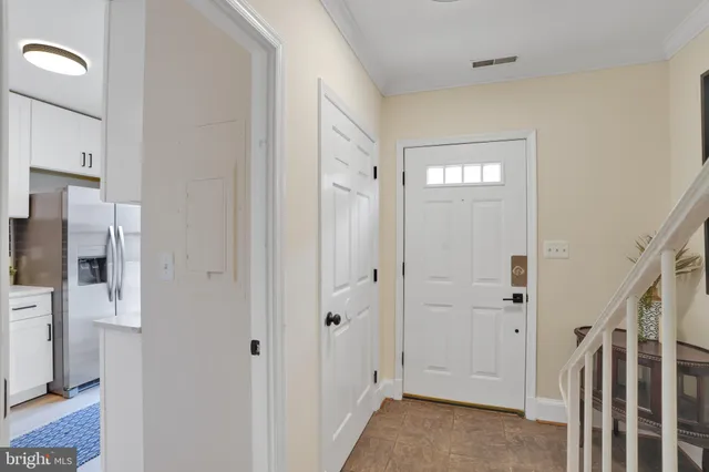 a view of a hallway with a livingroom and a window