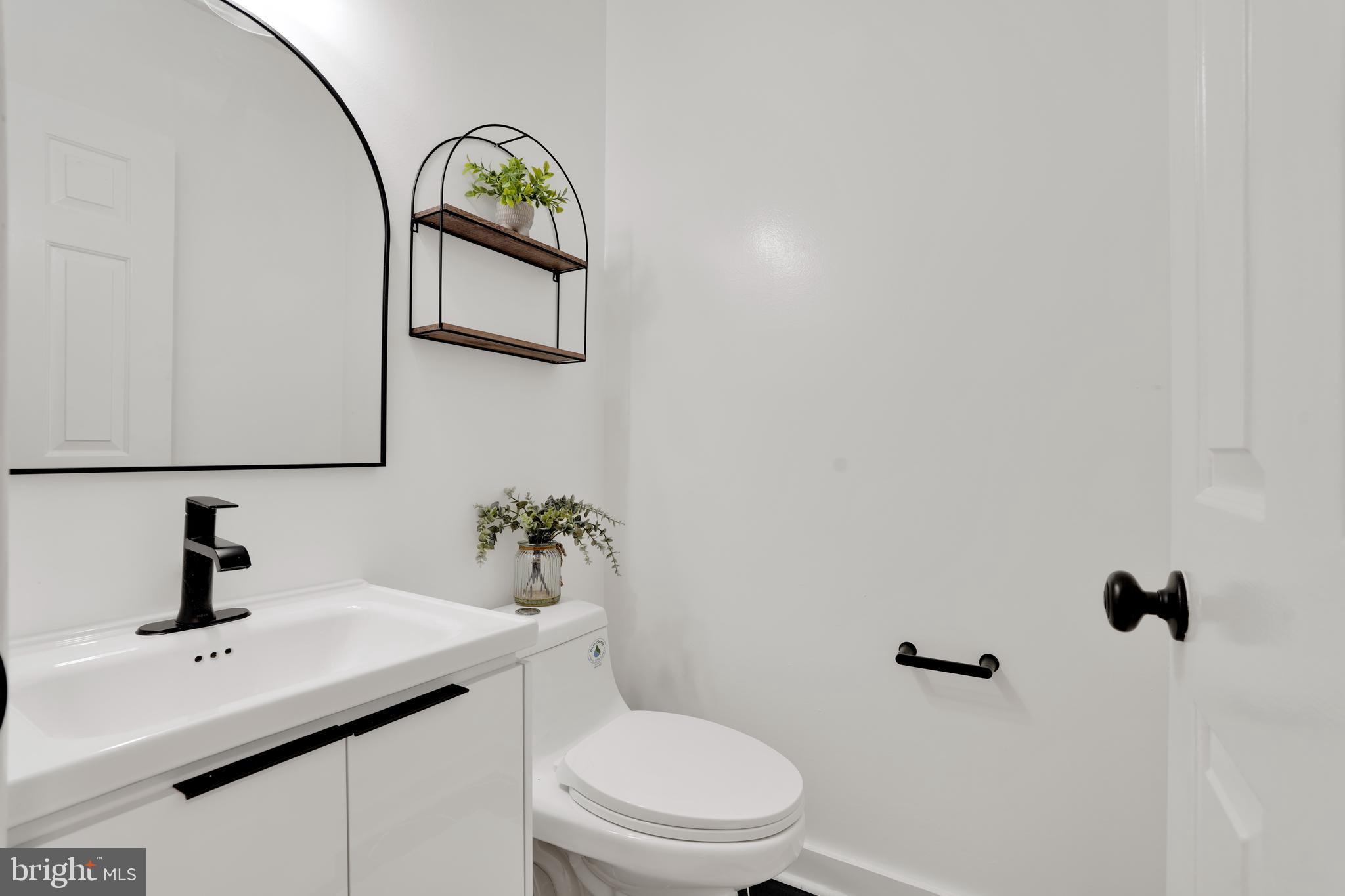 4339 Massachusetts Avenue Northwest, Unit 4339 Washington, DC 20016 - Photo 10 of 25 a bathroom with a toilet a sink and mirror