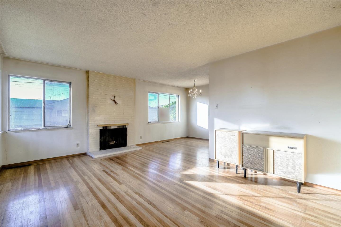 20948 Ashfield Avenue Castro Valley, CA 94546 - Photo 2 of 8 an empty room with wooden floor and windows