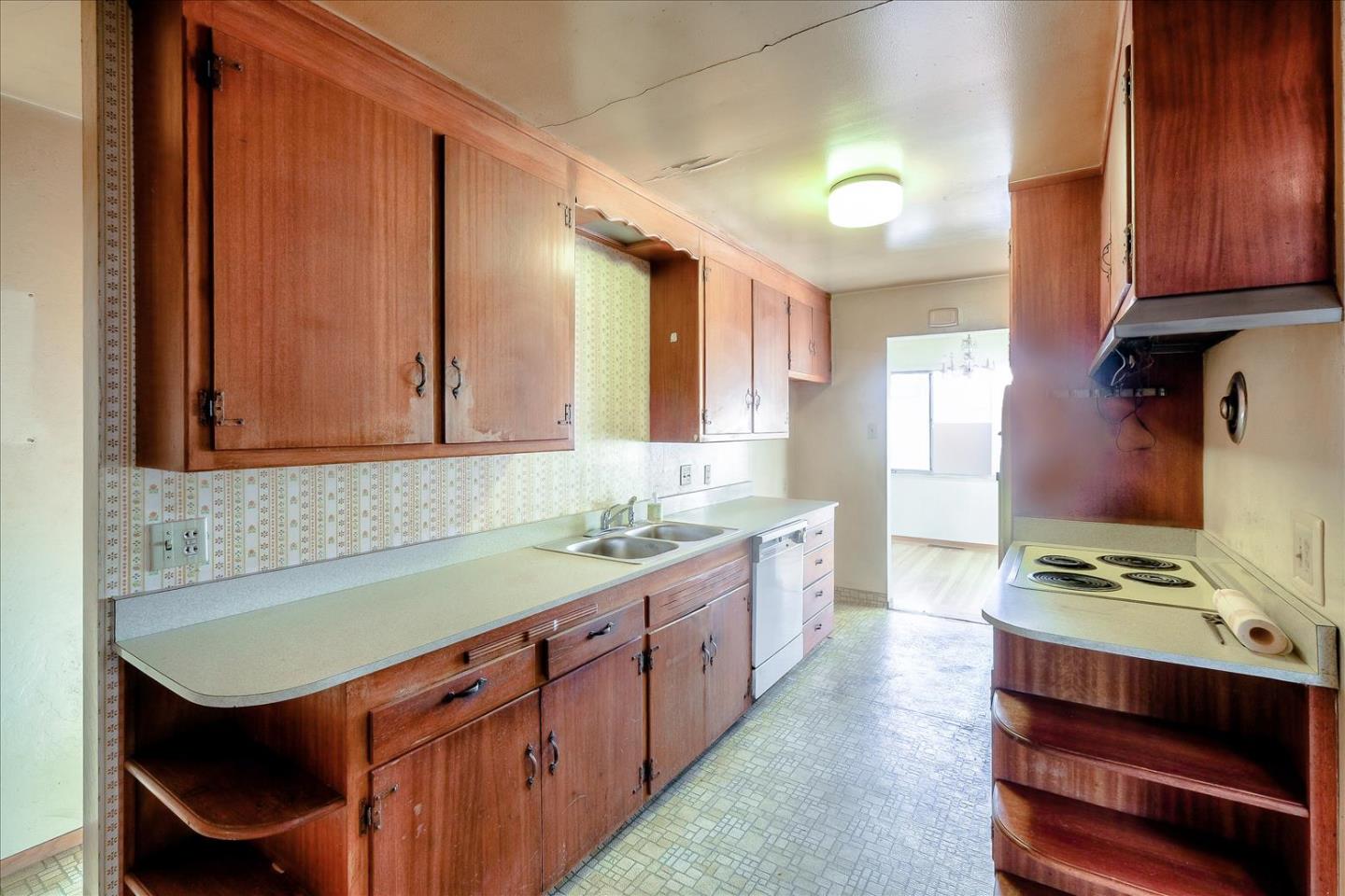 20948 Ashfield Avenue Castro Valley, CA 94546 - Photo 4 of 8 a kitchen with a sink cabinets and window