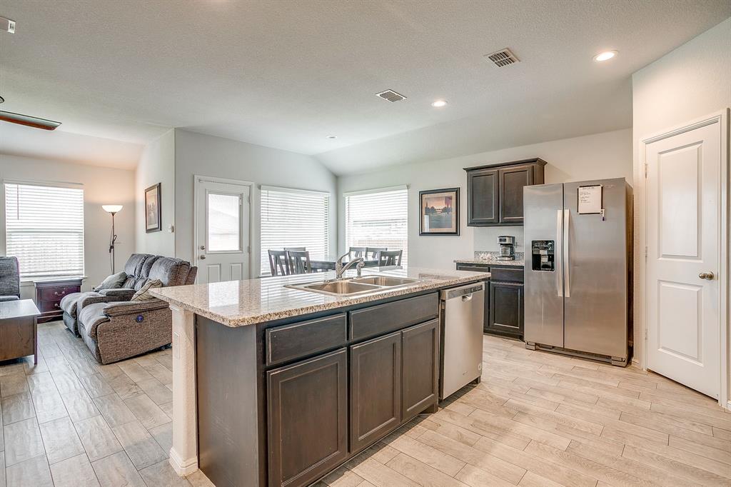 2313 Stallings Road Fort Worth, TX 76108 - Photo 11 of 30 a kitchen with kitchen island a sink stainless steel appliances and cabinets