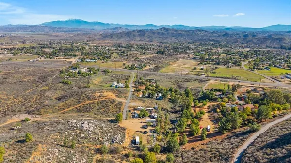an aerial view of residential house and sandy dunes