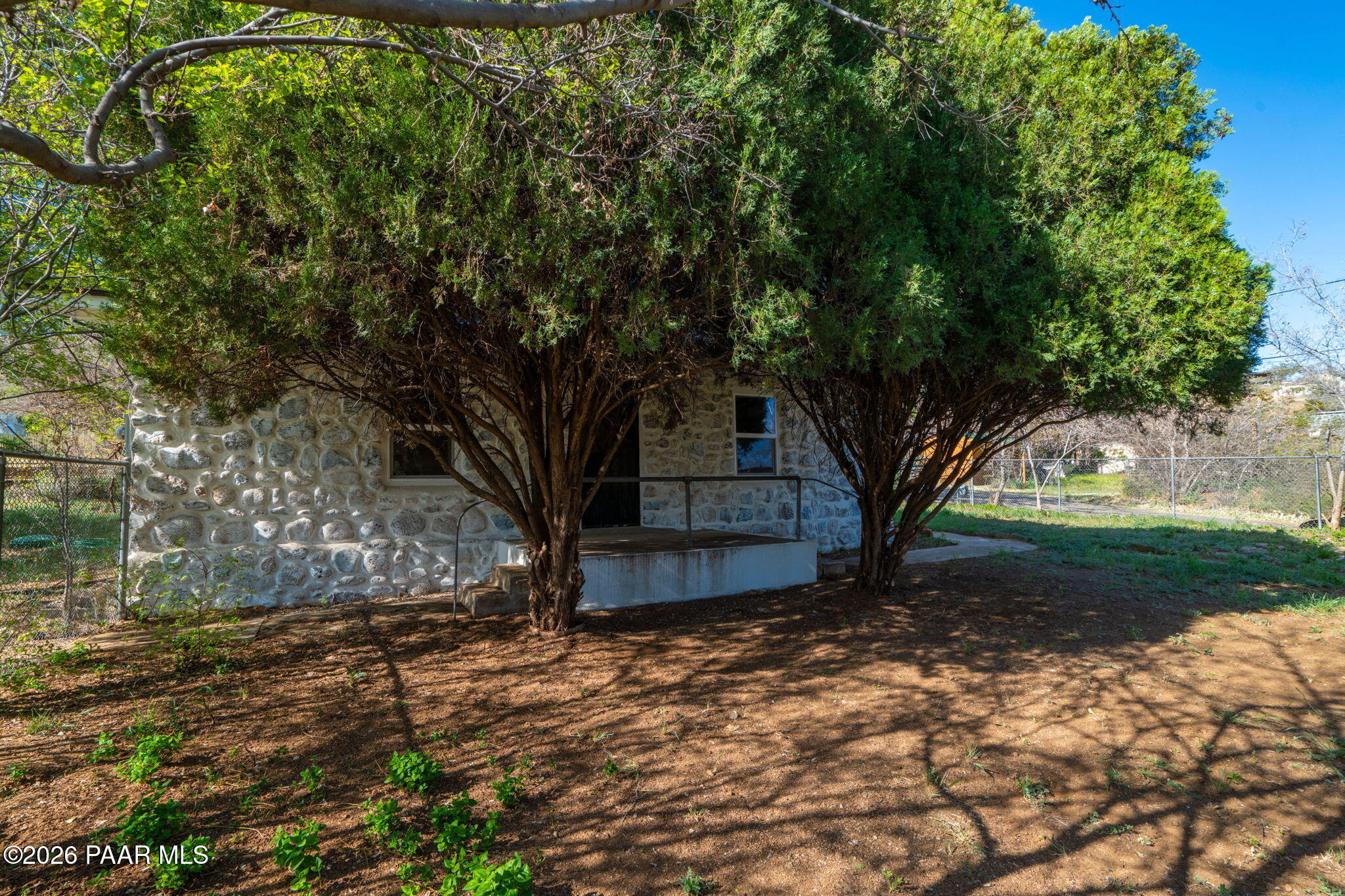 10101 Third Street Mayer, AZ 86333 - Photo 1 of 23 a view of a backyard with large trees