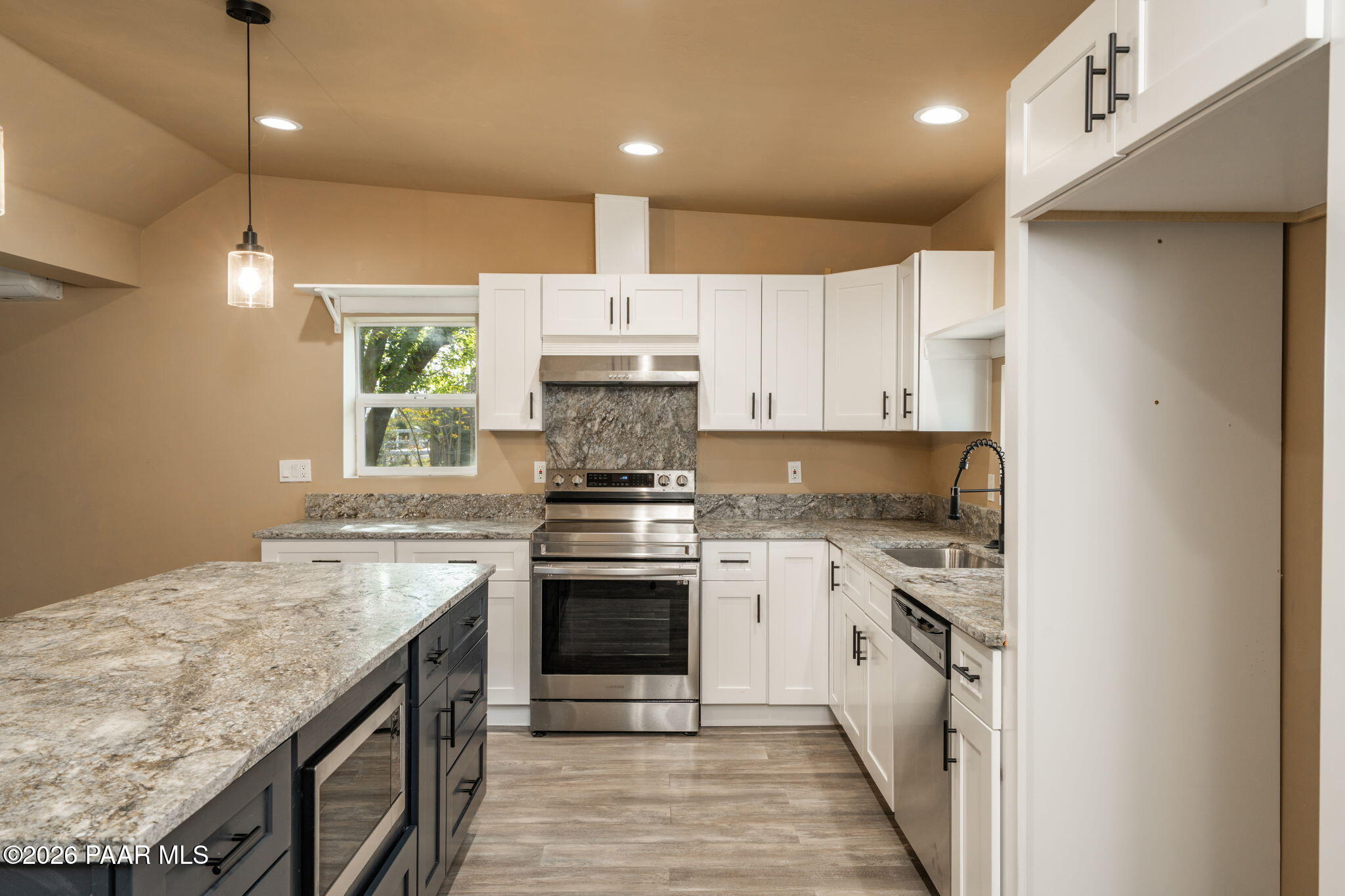 10101 Third Street Mayer, AZ 86333 - Photo 9 of 23 a kitchen with a stove sink and cabinets