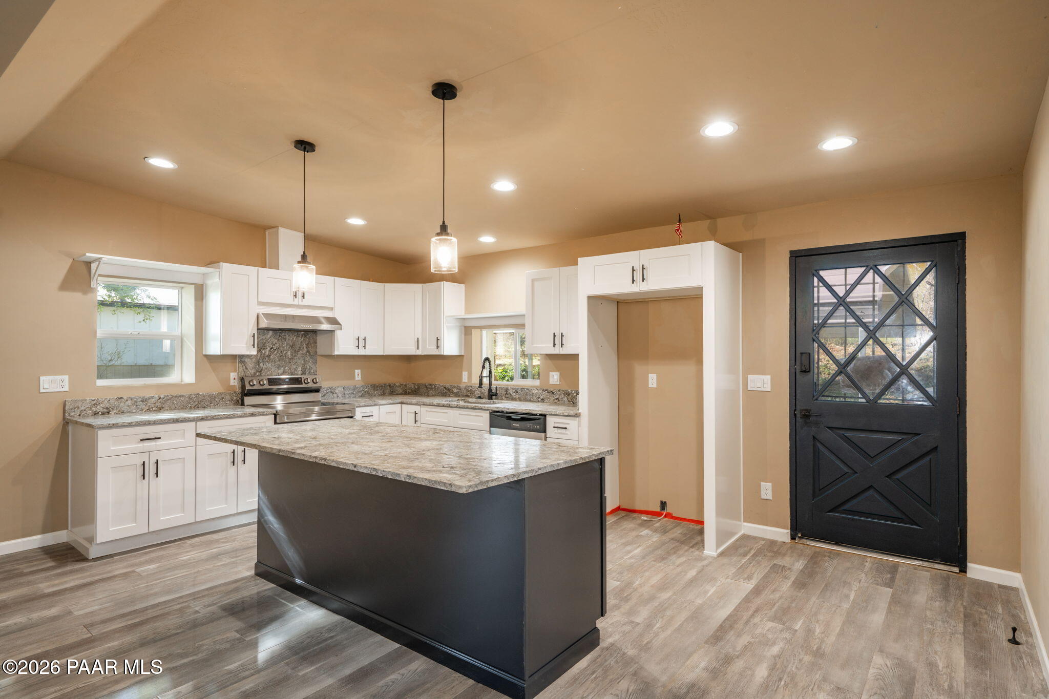 10101 Third Street Mayer, AZ 86333 - Photo 10 of 23 a large kitchen with kitchen island a sink stainless steel appliances and cabinets