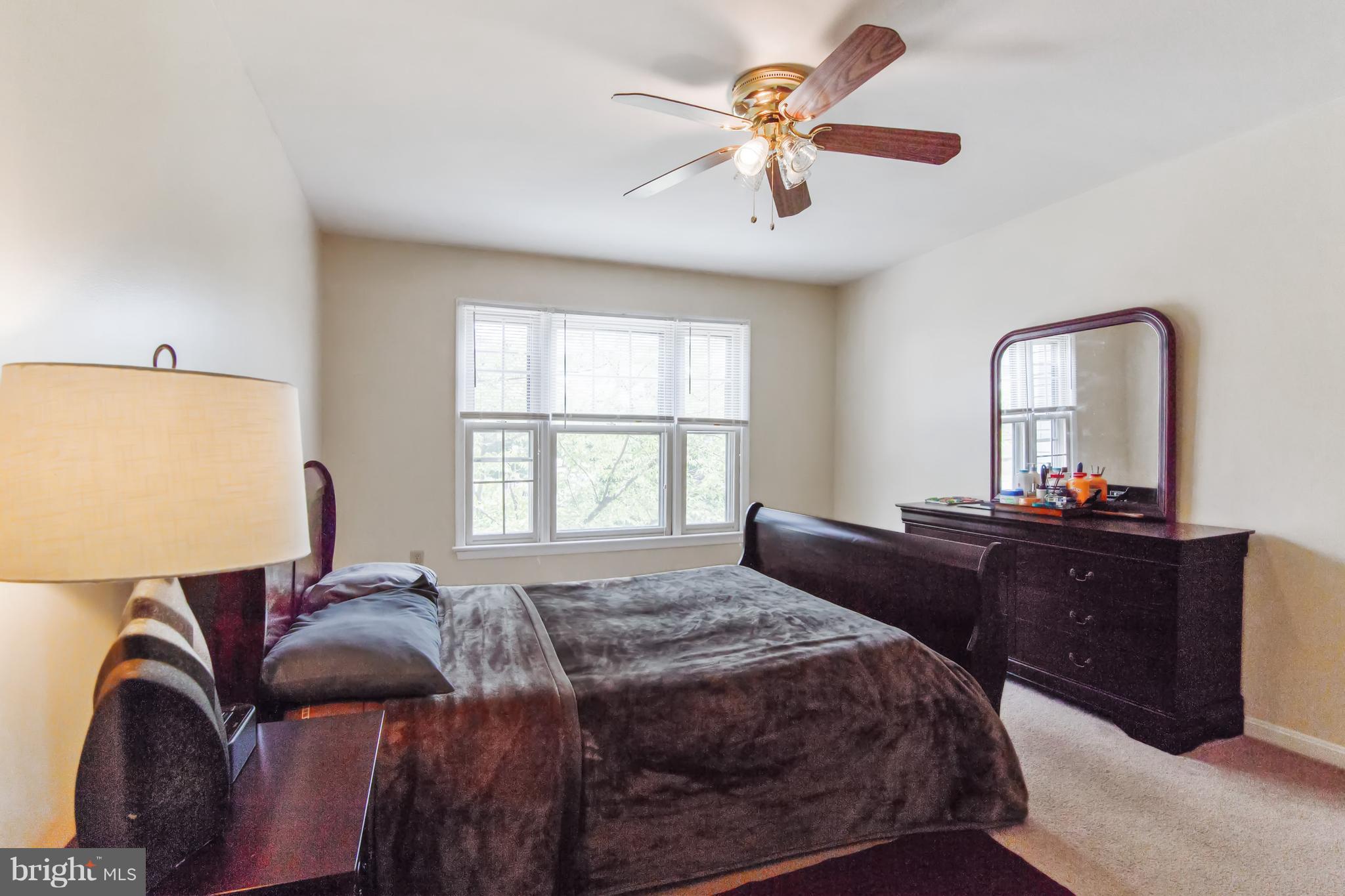 9304 Palmer Place, Unit 5 Laurel, MD 20708 - Photo 24 of 30 a bed room with a bed and a television