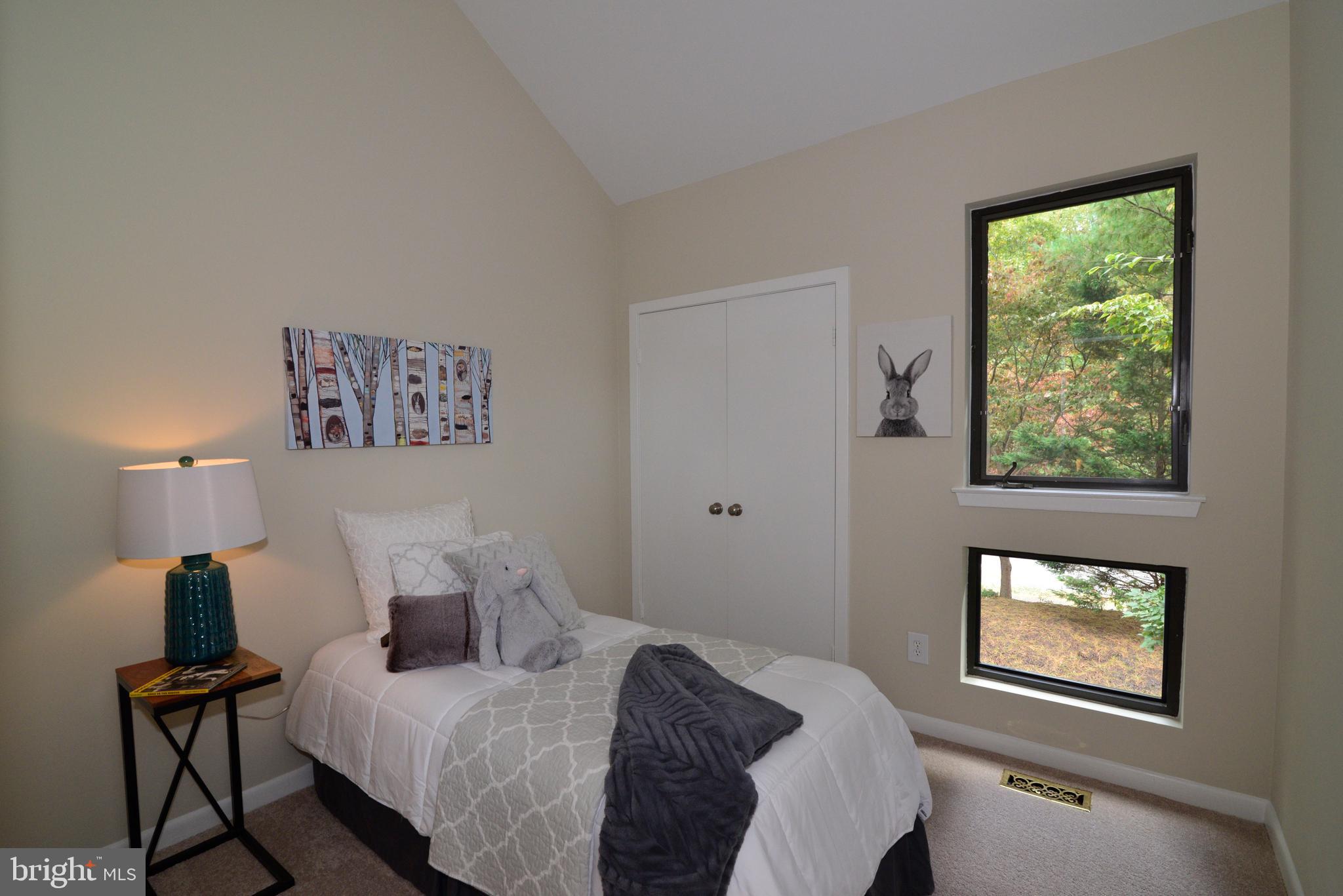 11013 Thrush Ridge Road Reston, VA 20191 - Photo 34 of 38 a bedroom with a bed and a lamp next to a window