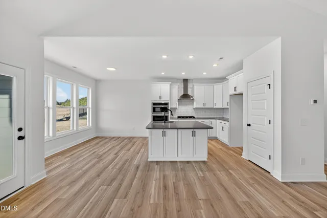 a kitchen with stainless steel appliances granite countertop a sink a stove and a refrigerator
