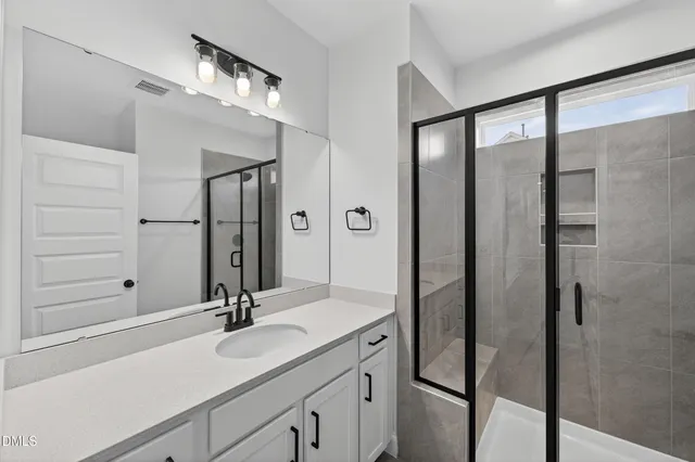 a bathroom with 2 sink and a mirror