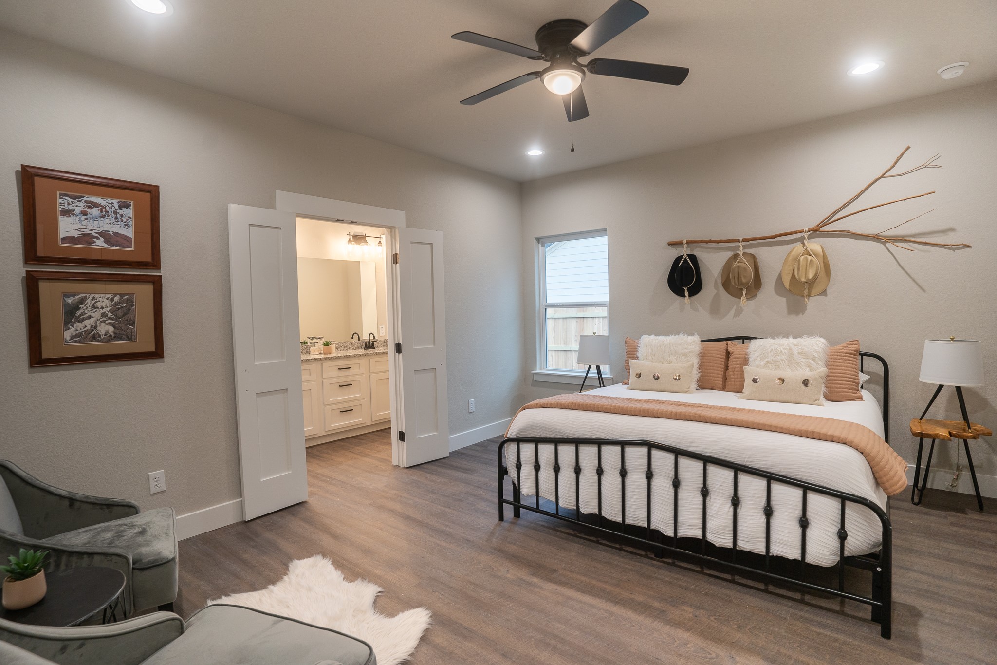 306 String Prairie Way Smithville, TX 78957 - Photo 13 of 25 Bedroom featuring baseboards, recessed lighting, ensuite bath, dark wood-type flooring, and a sink