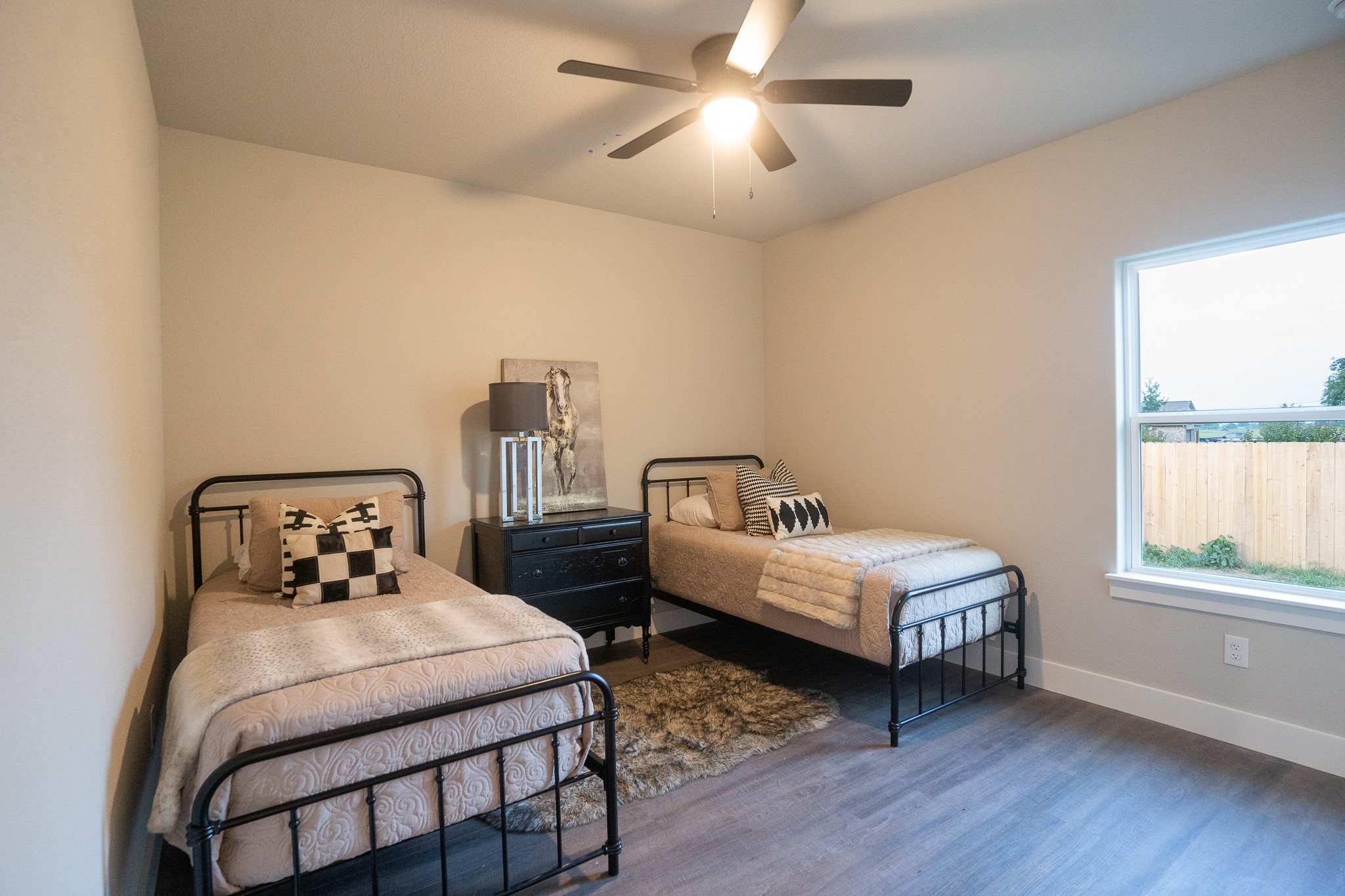 306 String Prairie Way Smithville, TX 78957 - Photo 16 of 25 Bedroom featuring wood finished floors, baseboards, and a ceiling fan