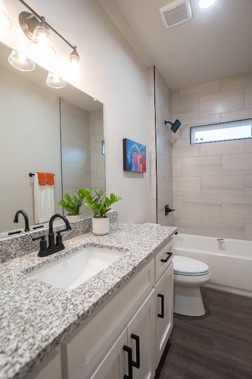 306 String Prairie Way Smithville, TX 78957 - Photo 19 of 25 Bathroom with vanity, toilet, wood finished floors, and shower / tub combination