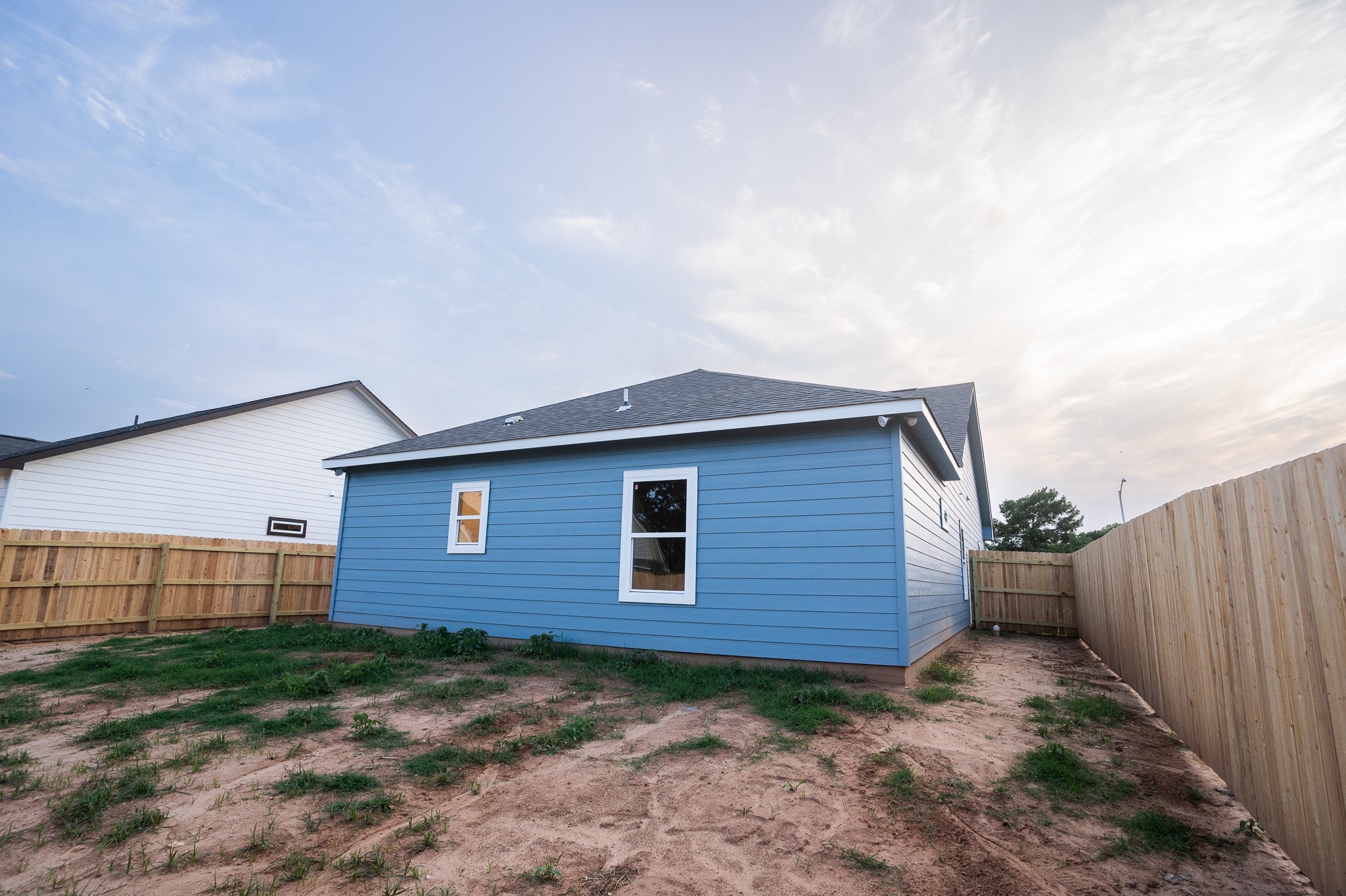306 String Prairie Way Smithville, TX 78957 - Photo 24 of 25 Rear view of house with a fenced backyard and roof with shingles