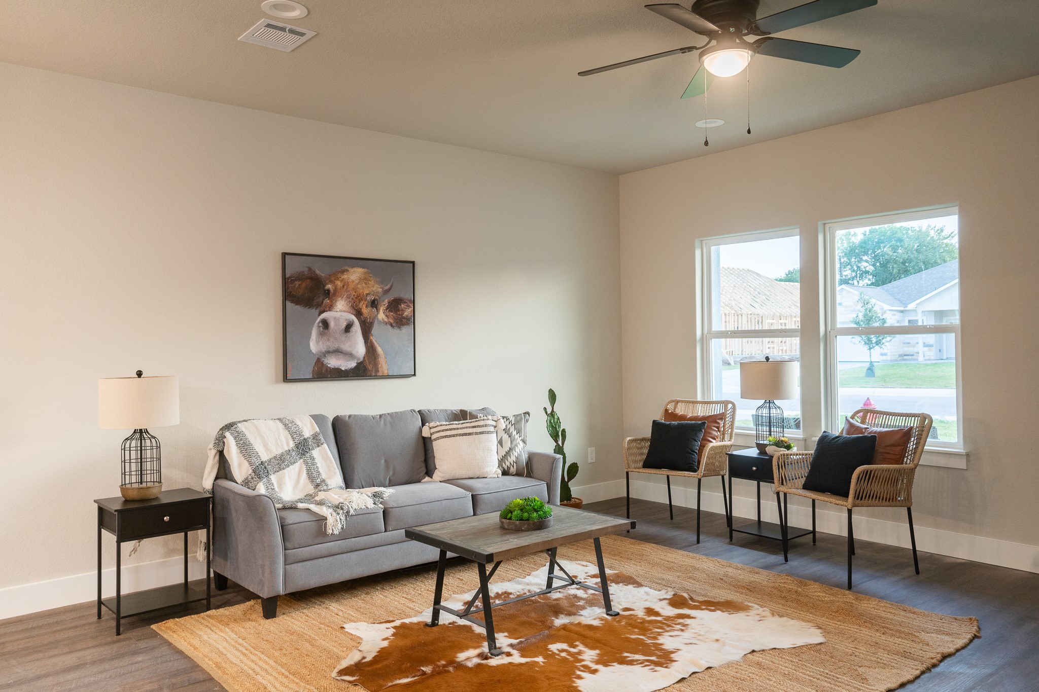 306 String Prairie Way Smithville, TX 78957 - Photo 4 of 25 Living area featuring baseboards, wood finished floors, and ceiling fan