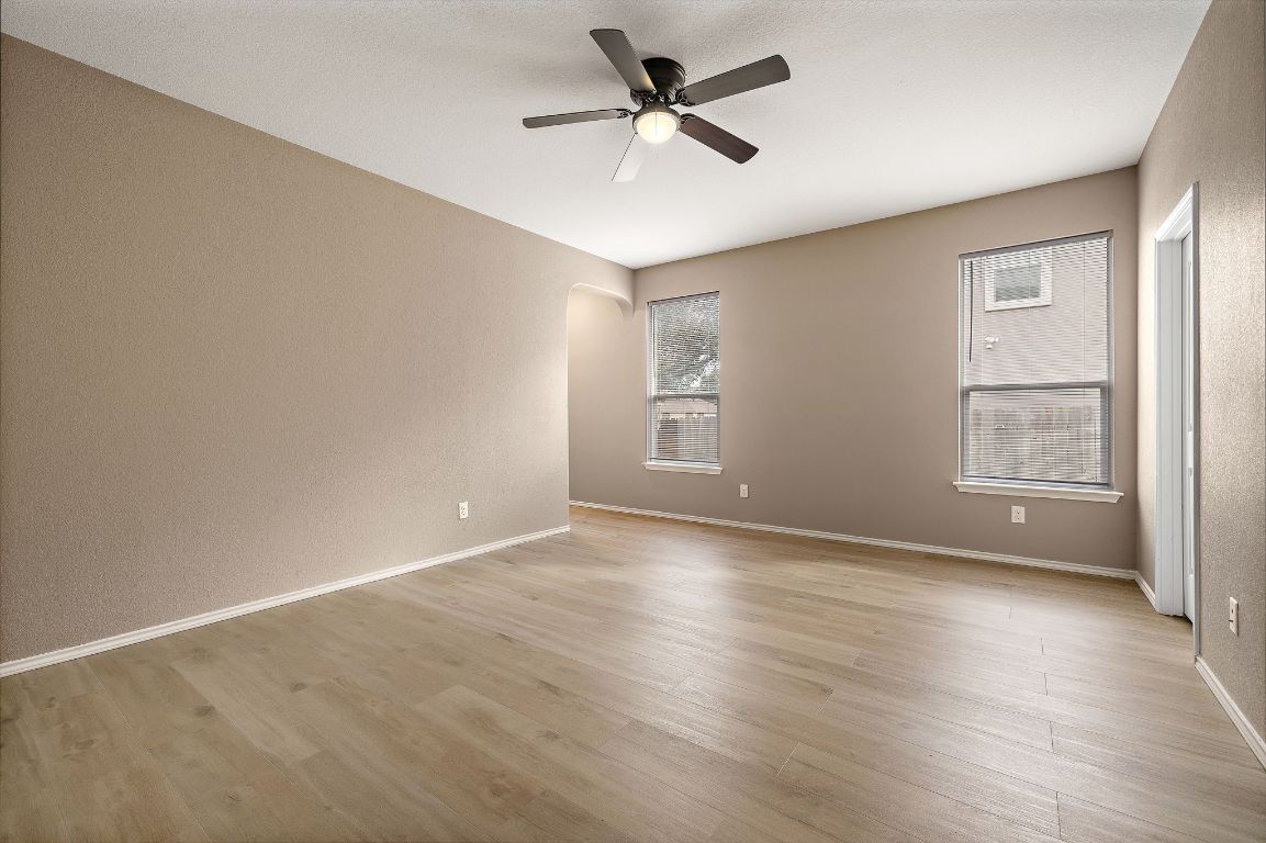 1012 Plano Lane Leander, TX 78641 - Photo 11 of 21 wooden floor in an empty room with a window
