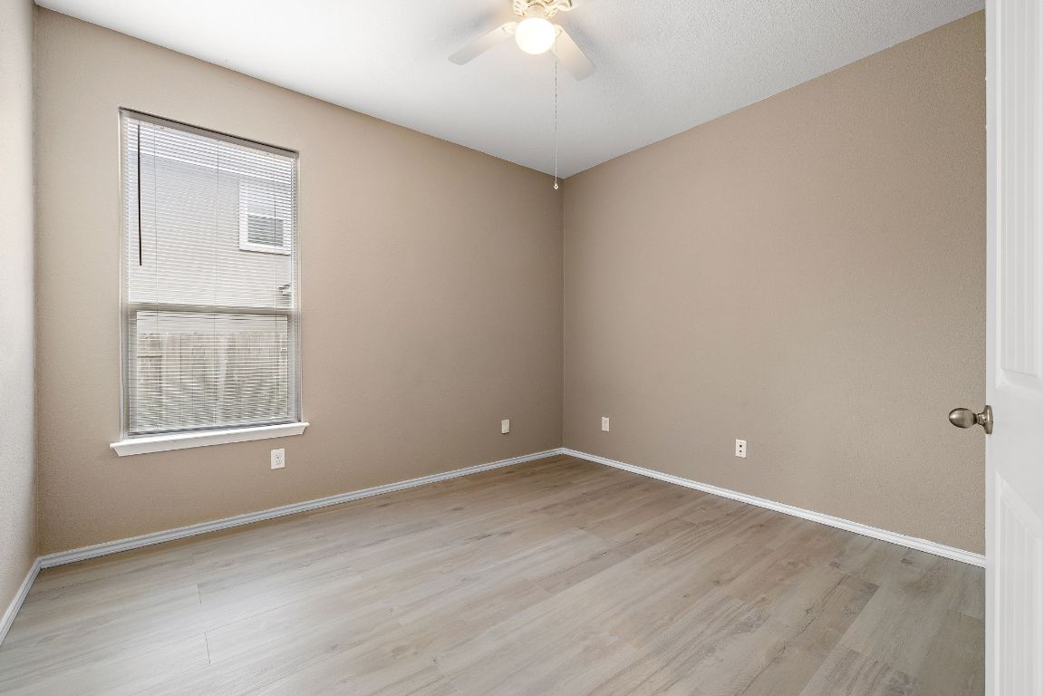 1012 Plano Lane Leander, TX 78641 - Photo 14 of 21 an empty room with chandelier fan and windows