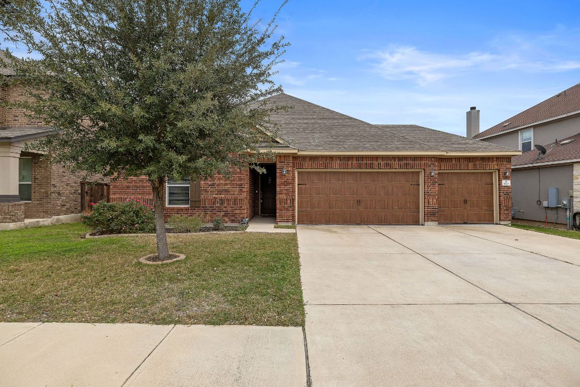 1012 Plano Lane Leander, TX 78641 - Photo 2 of 21 a front view of a house with a yard and garage