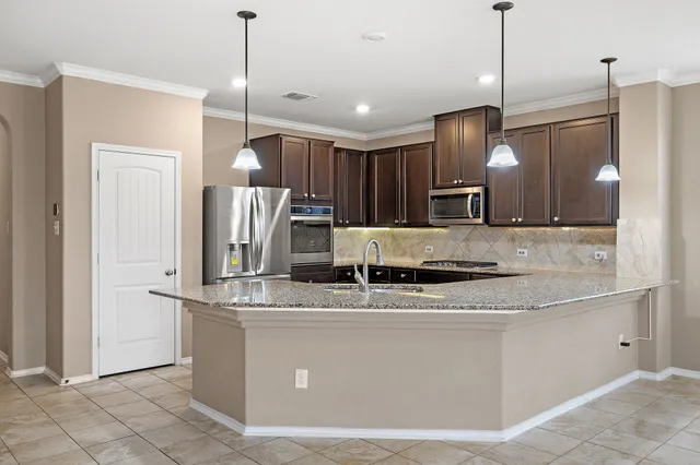 a large kitchen with stainless steel appliances kitchen island a large island in the center