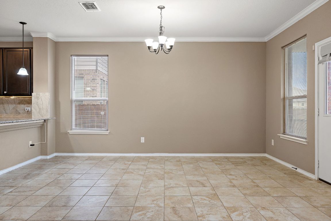 1012 Plano Lane Leander, TX 78641 - Photo 10 of 21 a view of a livingroom with a chandelier fan and windows
