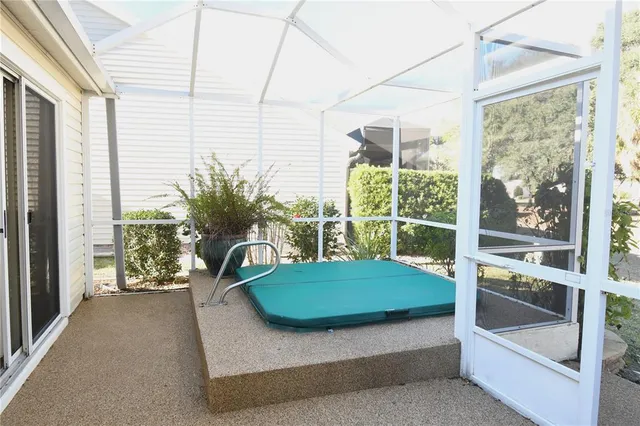 a white house with a large tree in front of it