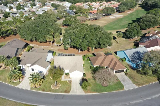 an aerial view of residential house with outdoor space and parking