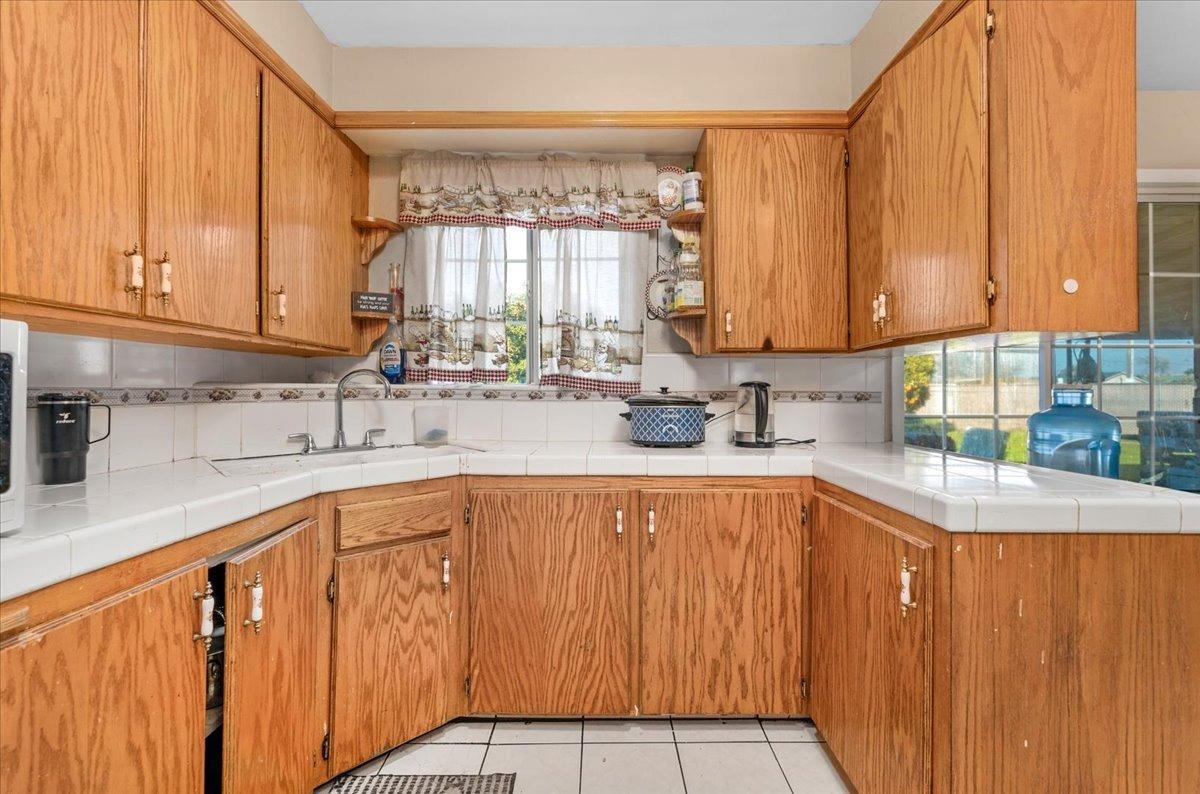 4185 East Turner Avenue Fresno, CA 93702 - Photo 11 of 39 a kitchen with stainless steel appliances a sink window and cabinets