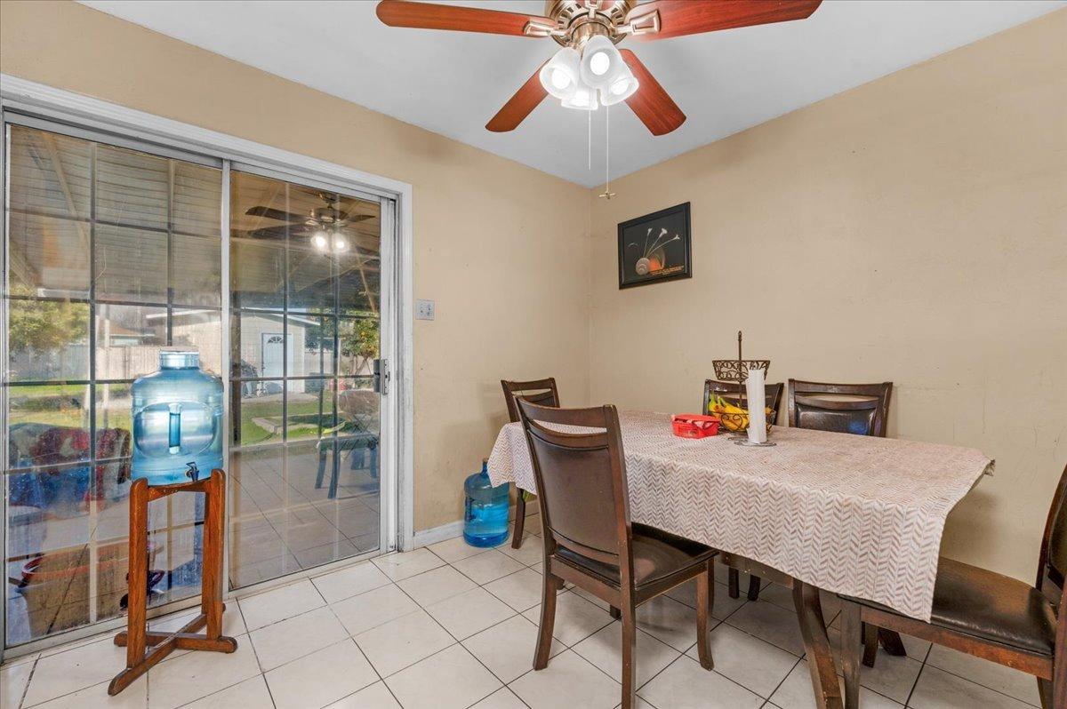 4185 East Turner Avenue Fresno, CA 93702 - Photo 12 of 39 a view of a dining room with furniture and a window