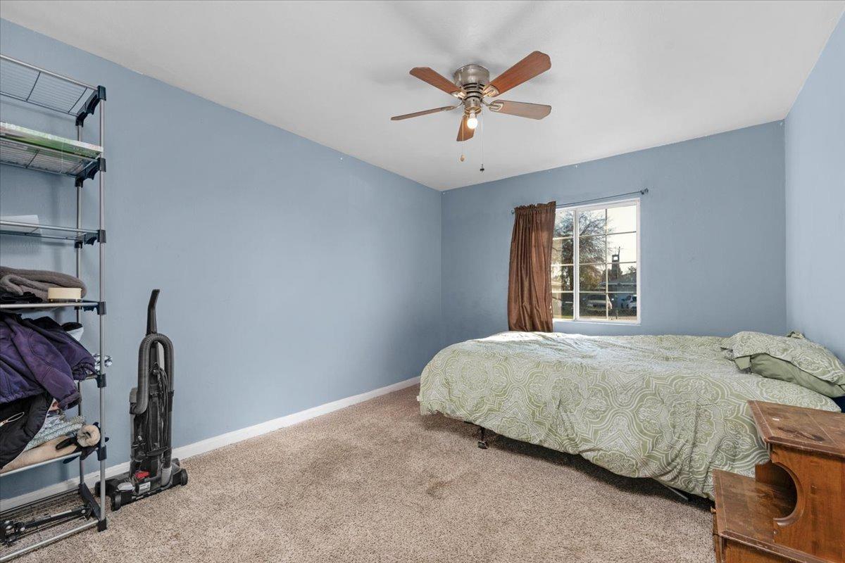 4185 East Turner Avenue Fresno, CA 93702 - Photo 14 of 39 a bedroom with a bed and a window
