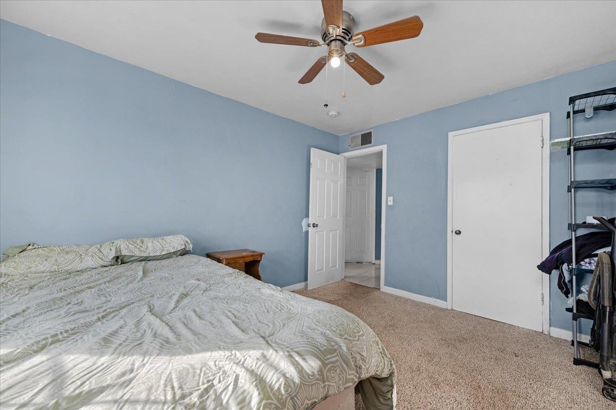 4185 East Turner Avenue Fresno, CA 93702 - Photo 15 of 39 a bedroom with a bed and a chandelier