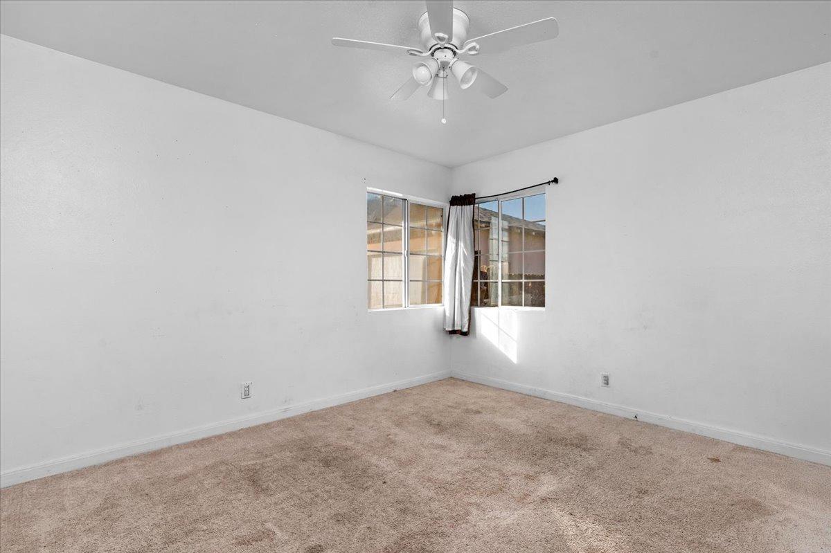 4185 East Turner Avenue Fresno, CA 93702 - Photo 17 of 39 en empty room with windows and ceiling fan