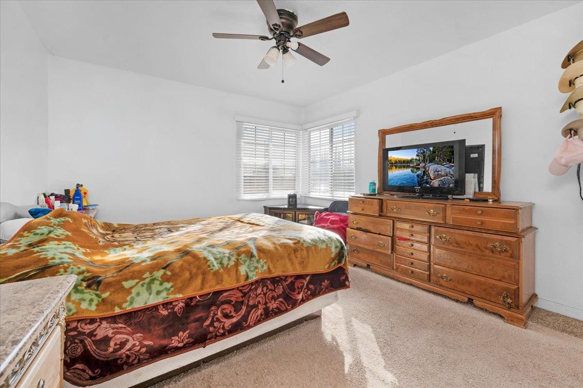4185 East Turner Avenue Fresno, CA 93702 - Photo 19 of 39 a bedroom with a bed and a dresser