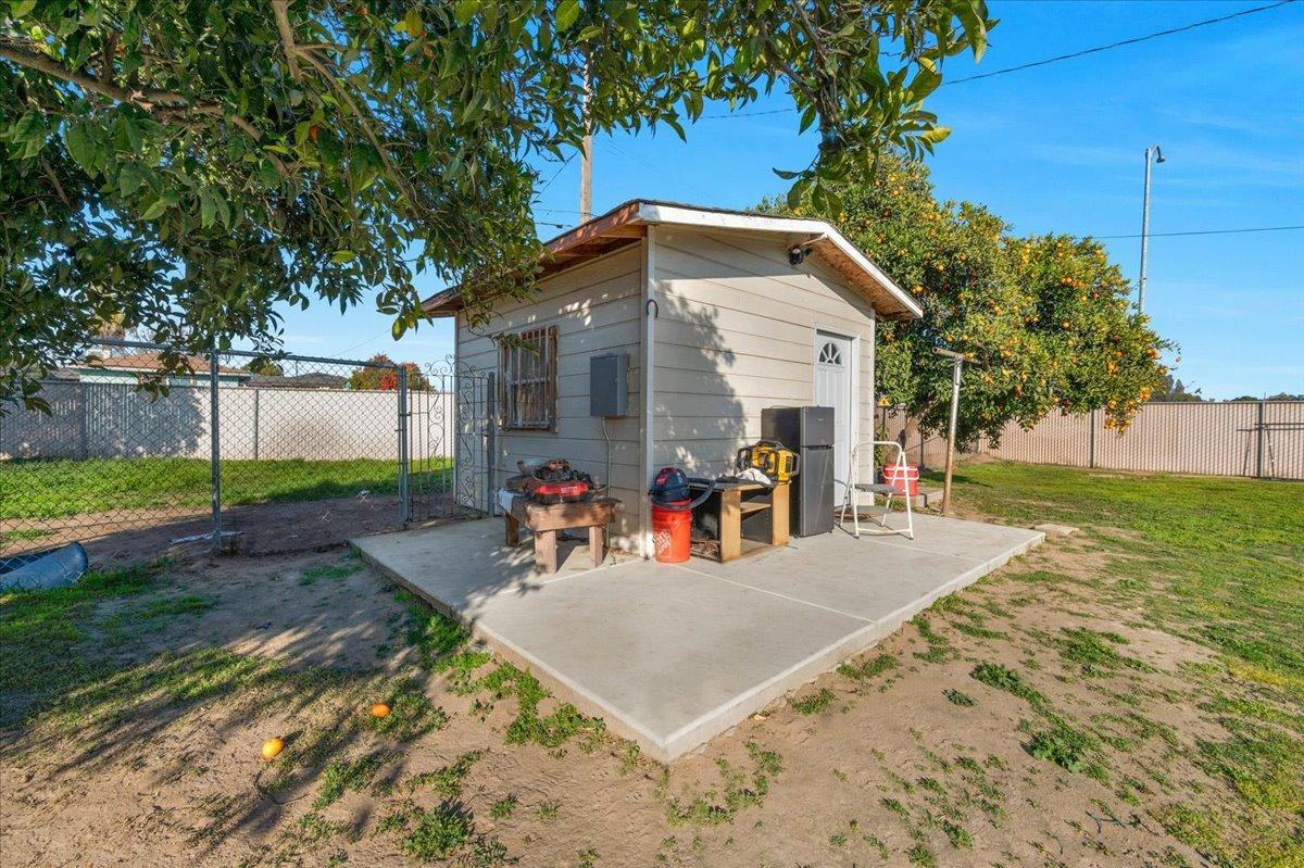 4185 East Turner Avenue Fresno, CA 93702 - Photo 32 of 39 a view of a house with backyard and a tree