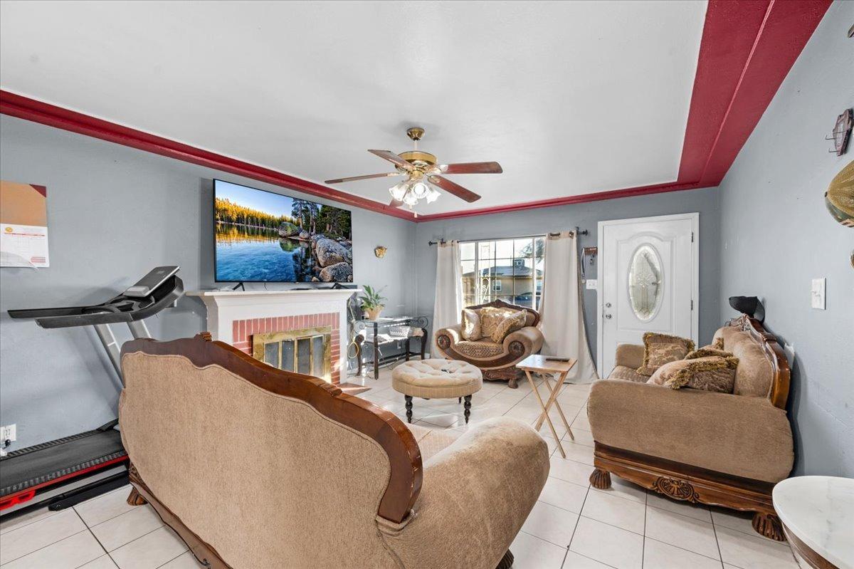 4185 East Turner Avenue Fresno, CA 93702 - Photo 7 of 39 a living room with furniture a flat screen tv and a large window