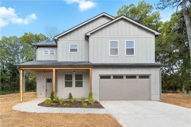 a front view of a house with a garden and porch