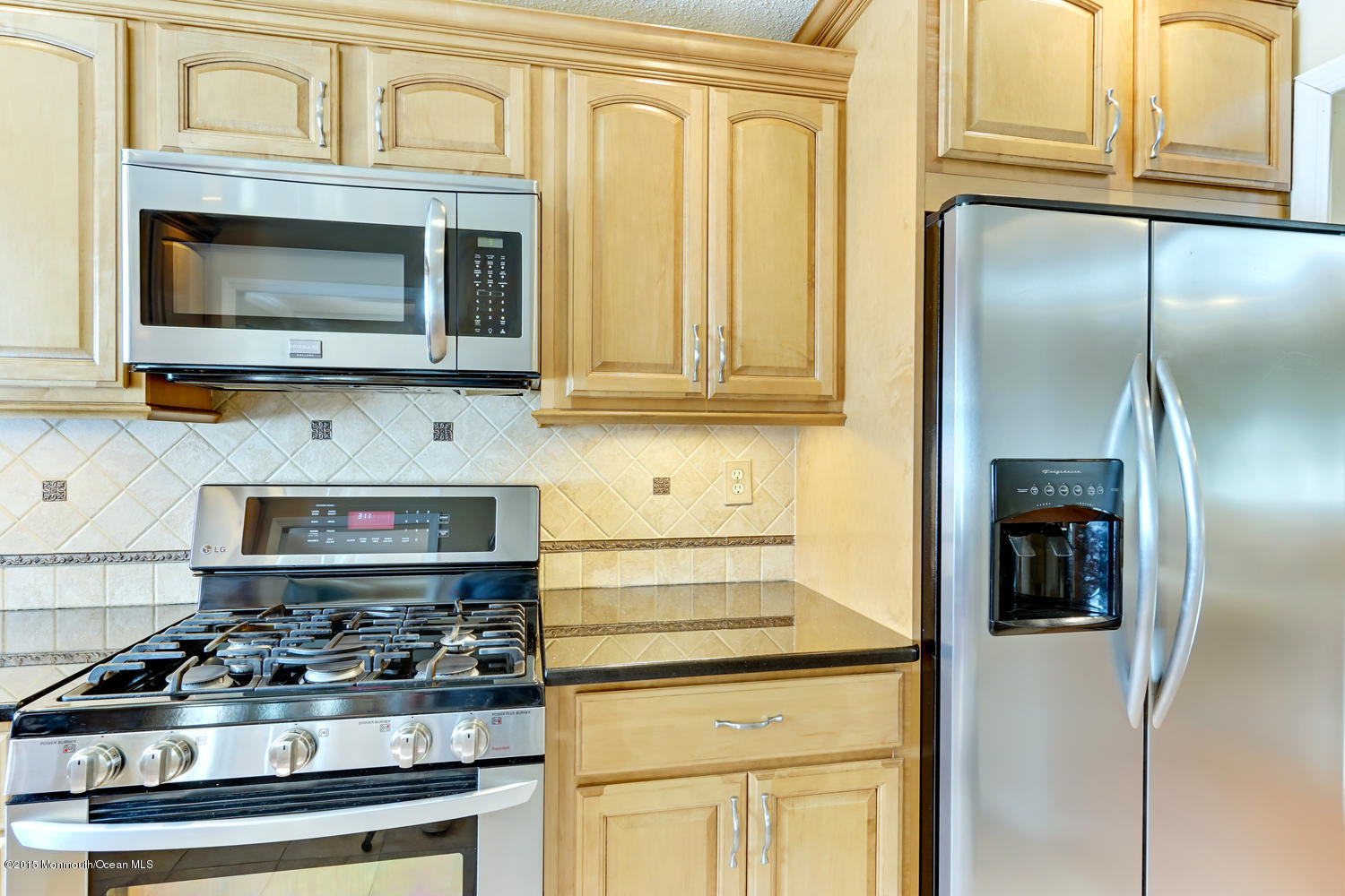6 Hickory Hill Road Jackson, NJ 08527 - Photo 25 of 53 a kitchen with stainless steel appliances granite countertop a stove and a microwave