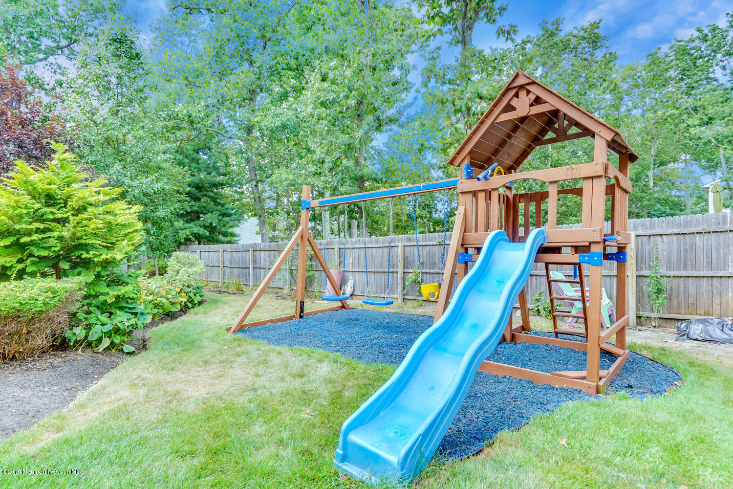 6 Hickory Hill Road Jackson, NJ 08527 - Photo 49 of 53 a view of a backyard with a slide and a child swing