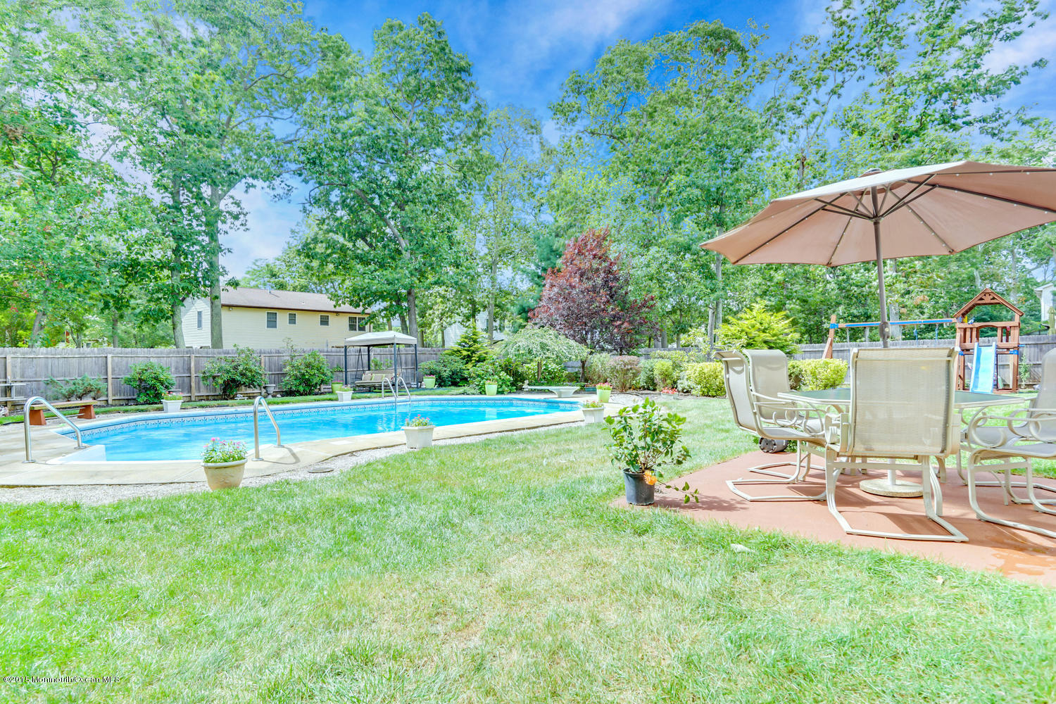 6 Hickory Hill Road Jackson, NJ 08527 - Photo 53 of 53 a view of a patio with a table and chairs under an umbrella