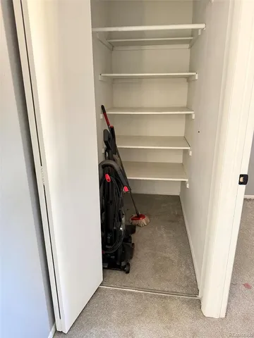 a view of walk in closet with empty racks