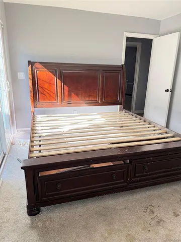 a bedroom with a bed and window