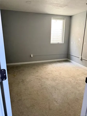 a view of an empty room and closet area