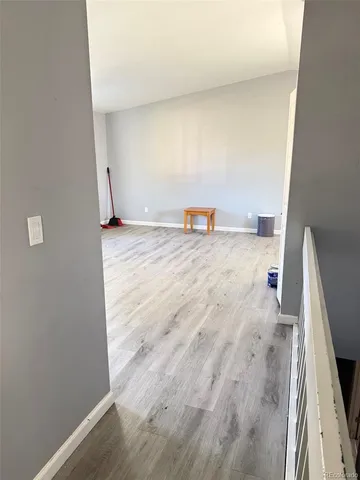 a view of a room with wooden floor