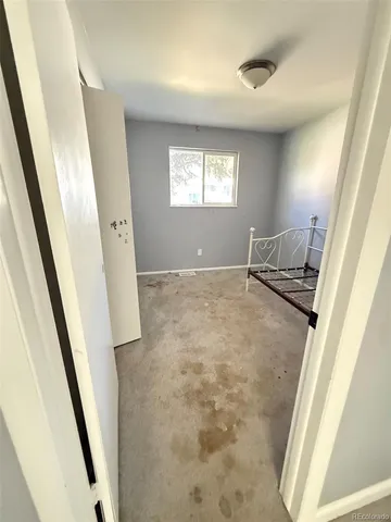 a view of an empty room and wooden floor