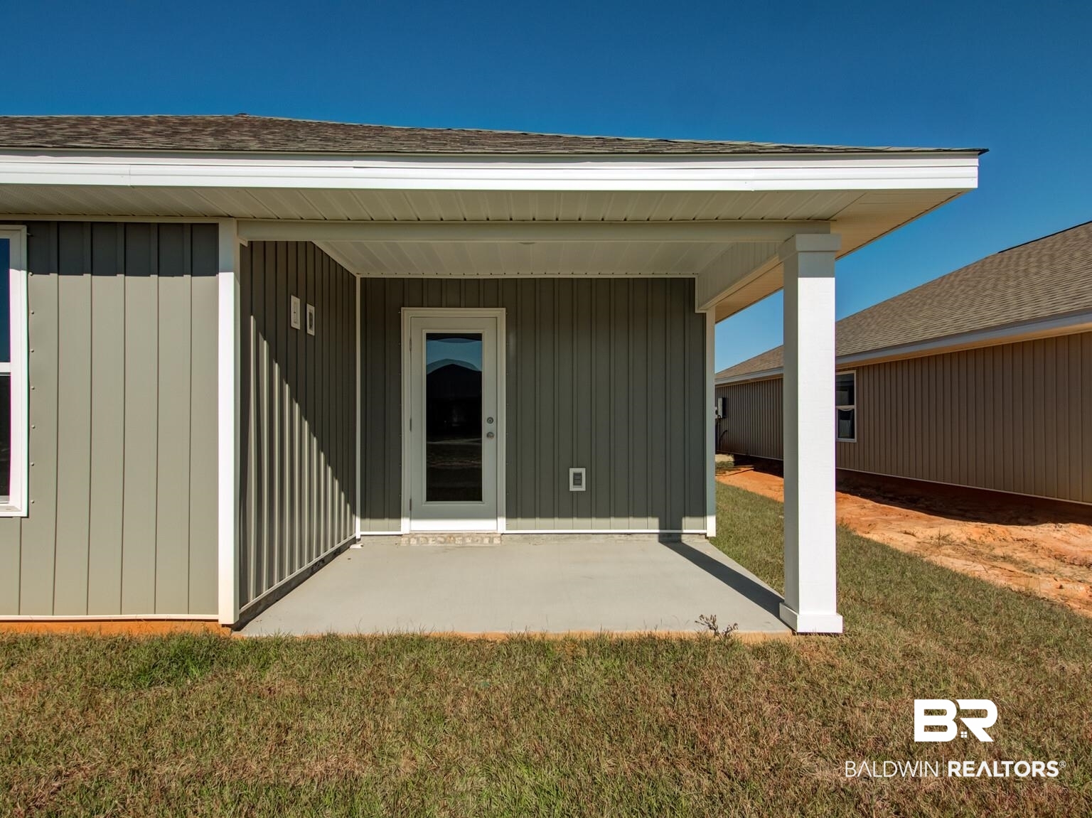 23953 Citation Loop Daphne, AL 36526 - Photo 33 of 49 View of exterior entry featuring a yard, a shingled roof, and a porch