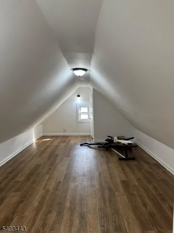 an empty room with wooden floor and window