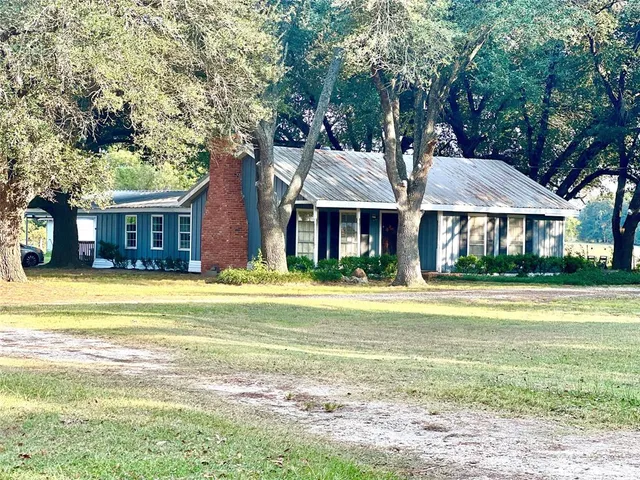 a front view of a house with swimming pool and porch
