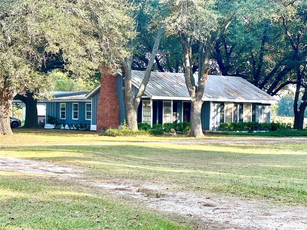 a front view of a house with swimming pool and porch