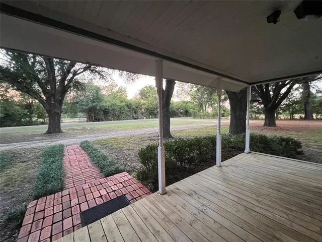 a view of backyard with a deck and wooden floor