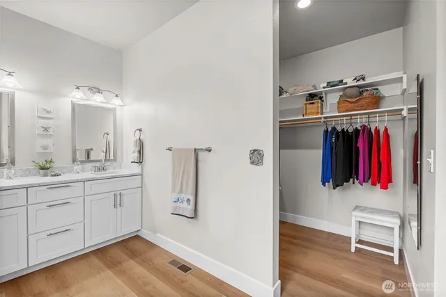 a view of walk in closet with clothes and shoes